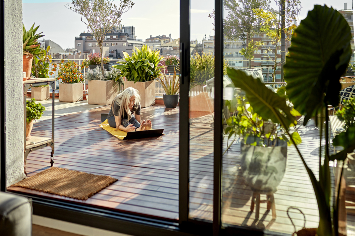 Caucasian Woman in Mid 60s Doing Yoga on Outdoor Deck